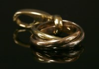 Lot 265 - A Cartier tri-colour gold 'Trinity' charm pendant