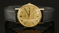 Lot 605 - A gentlemen's 9ct gold Omega Genève mechanical strap watch