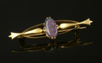 Lot 114 - A gold single stone black opal bar brooch