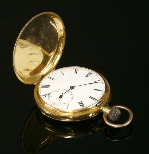 Lot 579 - A gold Hunter side wind Swiss pocket watch
