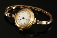 Lot 201 - A ladies' 15ct gold left handed mechanical bracelet watch