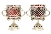 Lot 690 - A pair of ruby Flush glass comports with white metal mounts having grape and vine decoration on pedestal bases