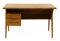 Lot 555 - A 1960s teak desk with a floating top