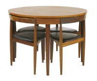 Lot 713 - A teak circular table and chair suite