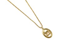 Lot 22 - A 9ct gold Capricorn pendant
