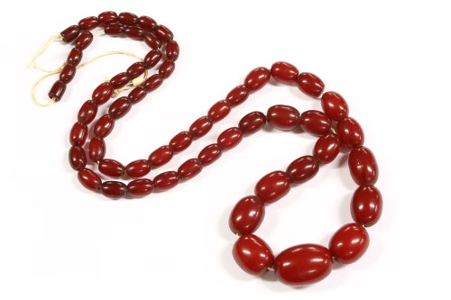 Lot 38 - A single row graduated cherry colour olive shaped bead necklace