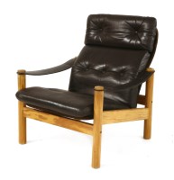 Lot 422 - A Danish pine and leather lounge armchair
