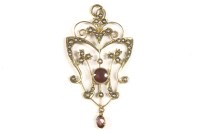 Lot 62 - An Edwardian split pearl and garnet open work scrolling pendant