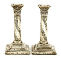 Lot 53 - A pair of Edwardian silver candlesticks