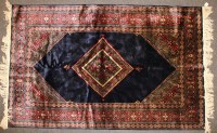 Lot 409 - A hand knotted Persian silk and woollen rug