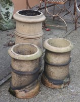 Lot 604 - A pair of terracotta chimney pots and one larger (3)