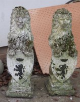 Lot 605 - A pair of reconstituted stone lions on hind legs with shields (2)