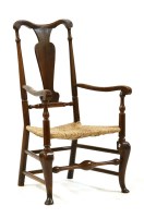 Lot 591 - An 18th century fruitwood countrymade elbow chair