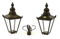Lot 454 - A pair of black painted wrought iron lanterns with glass panels