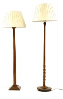 Lot 534 - Two 20th century walnut standard lamps
