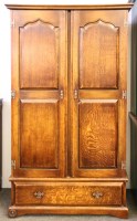Lot 380 - An early 20th century oak two door wardrobe