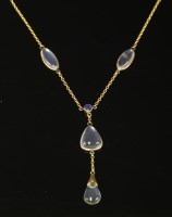 Lot 105 - An Edwardian gold moonstone and sapphire 'Y' necklace