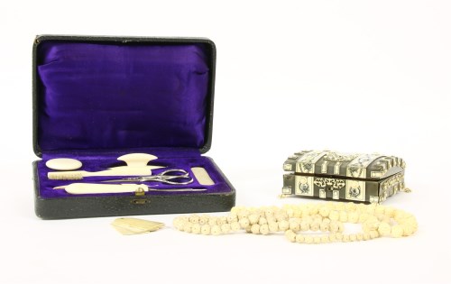 Lot 100 - A late 19th Century ivory mounted and engraved games box with counters