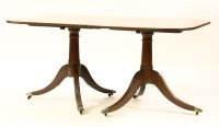 Lot 441 - A Regency design twin pillar mahogany dining table