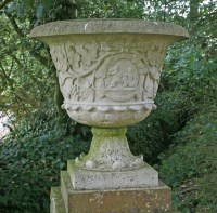Lot 598 - A pair of composition stone urns