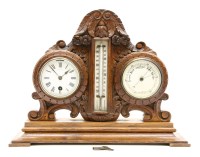 Lot 311 - A Victorian carved oak mantel clock/barometer