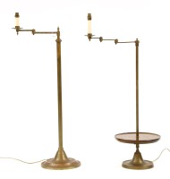 Lot 567 - Two brass floor lights with adjustable arms