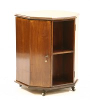 Lot 361 - A mahogany octagonal drinks cabinet bookcase