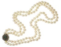 Lot 36 - A two row uniform cultured pearl necklace with an emerald cabochon and diamond floral cluster clasp