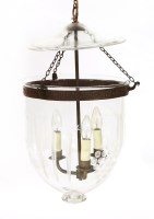 Lot 560 - A modern ceiling-mounted clear glass hall/storm light