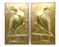 Lot 205 - A pair of Indian pressed brass relief panels of falcons