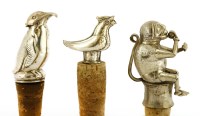 Lot 16 - Four cast white metal bottle stoppers