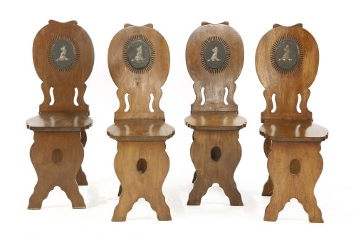 Lot 811 - A set of four George II mahogany hall chairs