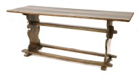 Lot 585 - An oak trestle table