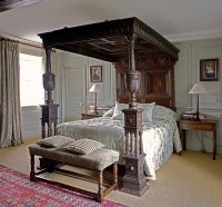 Lot 600 - An impressive inlaid and carved oak tester bed
