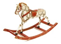 Lot 489 - A painted wooden and hessian rocking horse