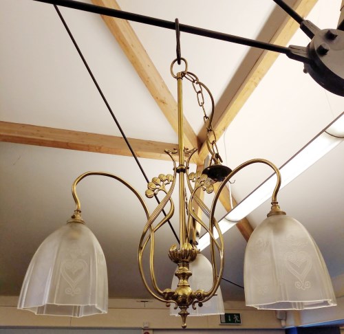 Lot 367 - An Art Nouveau brass three light electrolier