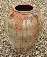 Lot 601 - A treacle glazed terracotta jar