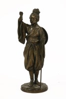 Lot 195 - A Japanese patinated bronze of a lady holding a torch