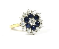 Lot 77 - A diamond and sapphire three-tier cluster ring