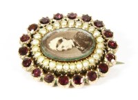 Lot 102 - A Victorian gold split pearl and garnet memorial brooch