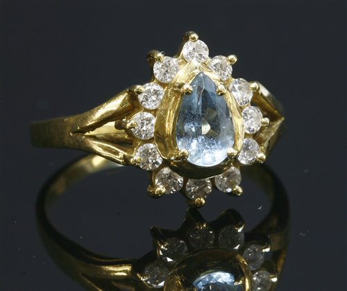 Lot 280 - An aquamarine and diamond gold cluster ring