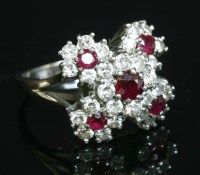Lot 514 - A white gold ruby and diamond cinquefoil cluster ring