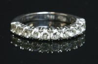 Lot 534 - A white gold diamond set half eternity ring