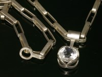 Lot 266 - A sterling silver Swedish rock crystal pendant and chain or belt