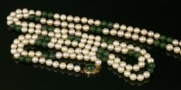 Lot 132 - A single row uniform cultured pearl and jade bead necklace