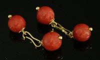 Lot 312 - A pair of French gold and coral cufflinks