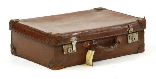 Lot 257 - A vintage brown leather suitcase 

Provenance: From the estate of the late Henry Wilson
