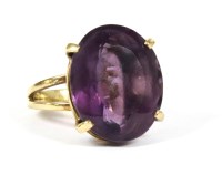 Lot 63 - A gold single stone oval cut mixed amethyst ring