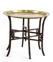 Lot 439 - A brass topped tray table