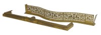 Lot 584 - A Georgian pierced brass serpentine fender